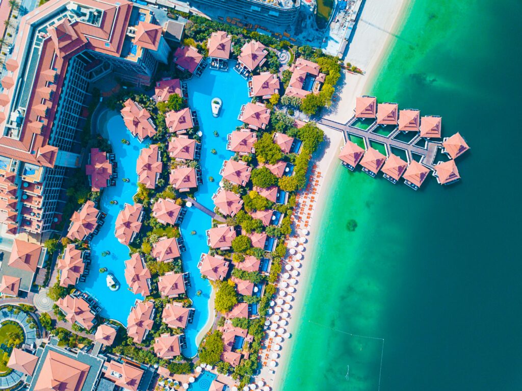pexels-photo-1488515-1488515 Stunning aerial shot of a luxurious Dubai beachfront resort with swimming pools.